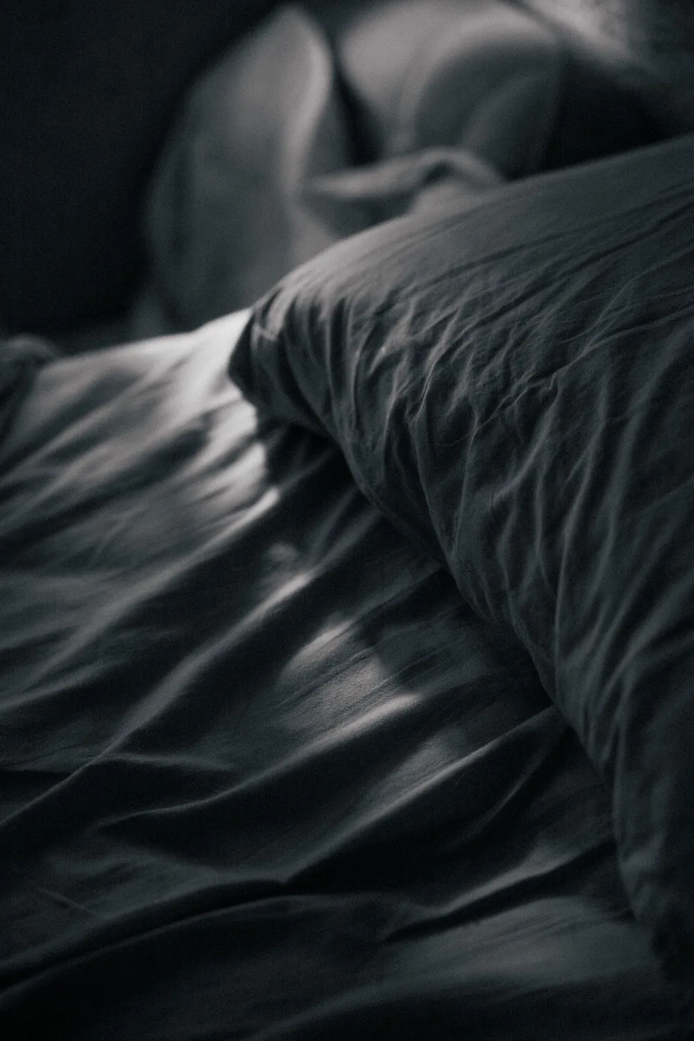 Dark linen bedding close-up: budget ways to cool a bed